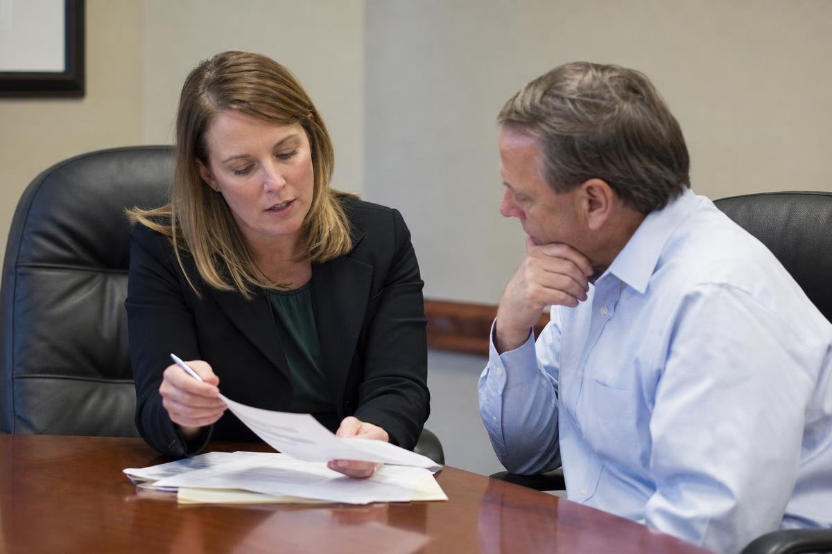 Defense attorney reviewing charging documents with a client in Alexandria, Virginia
