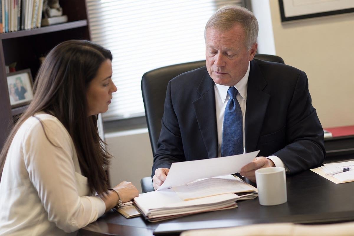 Alexandria family law attorney reviewing custody and support documents with a client